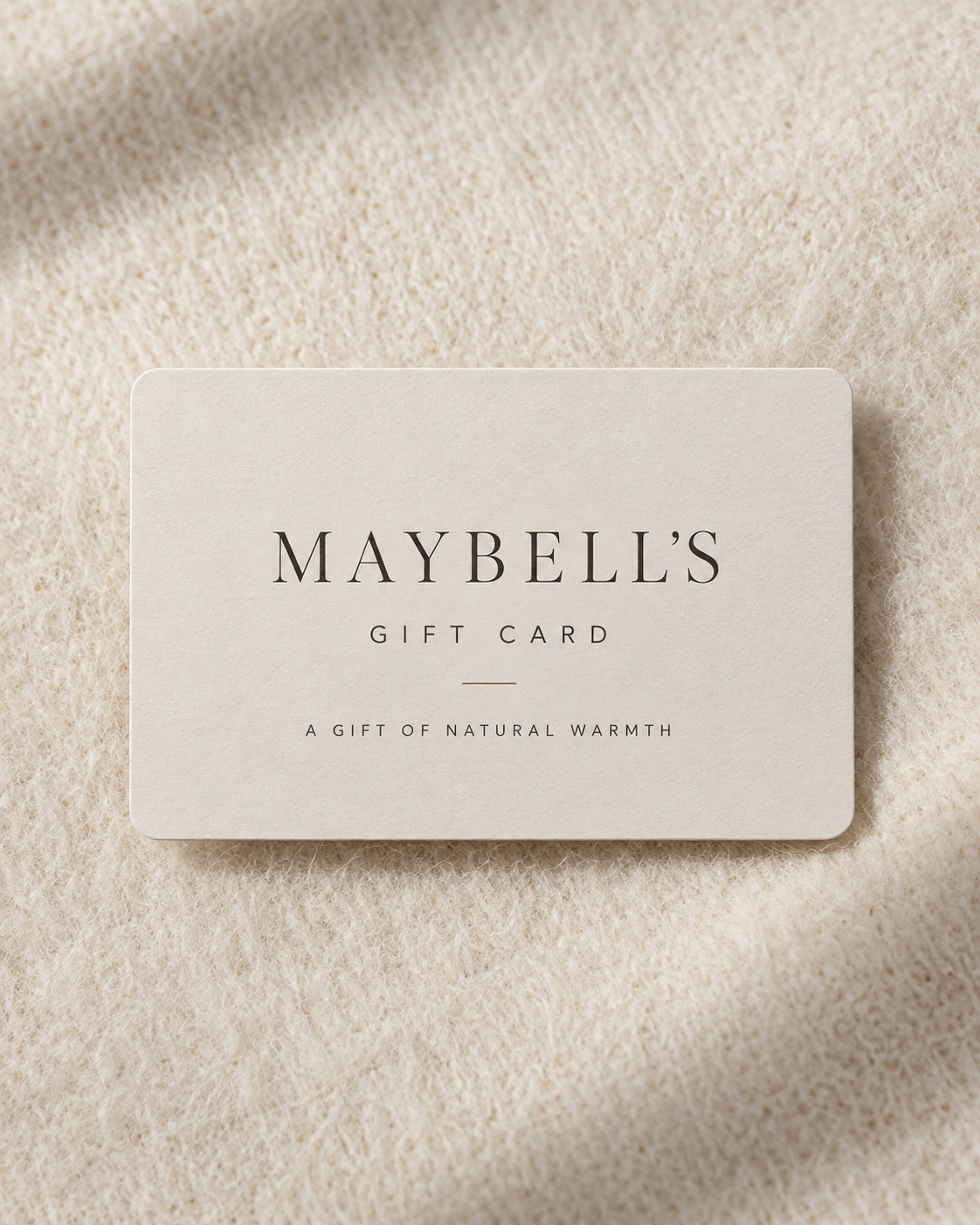 Maybell’s Geschenkgutschein auf natürlicher Wolltextur